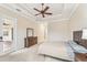 Main bedroom with dresser, access to patio, and ceiling fan at 20345 Reale Cir, Venice, FL 34293