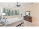 Main bedroom with backyard access and tray ceiling at 20345 Reale Cir, Venice, FL 34293