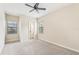 Well-lit bedroom with ceiling fan, carpet flooring, and large windows at 20345 Reale Cir, Venice, FL 34293