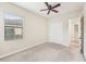 Spacious bedroom with ceiling fan, carpet, and ample closet space at 20345 Reale Cir, Venice, FL 34293