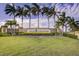 Grand Paradiso entrance sign with lush landscaping and palm trees at 20345 Reale Cir, Venice, FL 34293