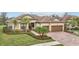 Two-story house with brown garage doors and brick driveway at 20345 Reale Cir, Venice, FL 34293