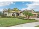 House exterior with a two-car garage and palm trees at 20345 Reale Cir, Venice, FL 34293