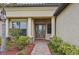 Front entry with columns, brick walkway, and landscaping at 20345 Reale Cir, Venice, FL 34293