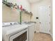 Laundry room with washer, dryer, shelving and additional storage at 20345 Reale Cir, Venice, FL 34293
