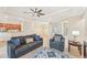 Living room with tile floor, gray sofas and view of kitchen at 20345 Reale Cir, Venice, FL 34293