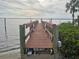 Wooden dock extends over calm water with great views at 215 Bahia Vista, Englewood, FL 34223