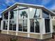 Bright sunroom addition with large windows and water views at 215 Bahia Vista, Englewood, FL 34223