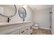 Bathroom with double vanity, quartz countertop, and black fixtures at 2173 S Haberland Blvd, North Port, FL 34288