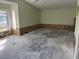 Large bedroom with damaged walls and flooring, awaiting renovation at 219 Periwinkle Plz, Anna Maria, FL 34216