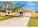 Cute yellow house with a new wooden fence and driveway at 2232 Hively St, Sarasota, FL 34231