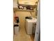 Functional laundry room with washer, dryer, and shelving at 22342 Augusta Ave, Port Charlotte, FL 33952