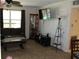 Living room with large TV, comfortable seating and display cabinet at 22342 Augusta Ave, Port Charlotte, FL 33952
