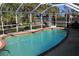 Relaxing kidney-shaped pool with screened enclosure at 22342 Augusta Ave, Port Charlotte, FL 33952