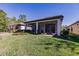 Well-maintained backyard with a screened-in lanai and lush landscaping, perfect for relaxation and privacy at 2479 Brassica Dr, North Port, FL 34289