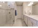 Modern bathroom with a glass shower, white cabinets, and double sinks providing both style and functionality at 2479 Brassica Dr, North Port, FL 34289