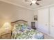 Comfortable bedroom featuring a ceiling fan, a cozy bed, and neutral wall colors for a relaxing atmosphere at 2479 Brassica Dr, North Port, FL 34289