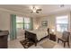 Cozy bedroom featuring a queen-sized bed, ample natural light, and tile flooring at 2479 Brassica Dr, North Port, FL 34289