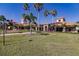 Beautiful community clubhouse with manicured lawns, palm trees, and inviting spaces for residents to enjoy at 2479 Brassica Dr, North Port, FL 34289