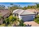 Attractive home showcasing a well-manicured lawn, gray tile roof, and a convenient two-car garage at 2479 Brassica Dr, North Port, FL 34289