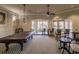 This game room features a pool table, seating area, neutral colors, ceiling fan, and access to the outdoors at 2479 Brassica Dr, North Port, FL 34289