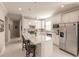 Bright kitchen featuring white cabinets, a quartz island, and stainless steel appliances at 2479 Brassica Dr, North Port, FL 34289