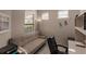 Comfortable office space with a beige futon, desk, and natural light from two windows at 2479 Brassica Dr, North Port, FL 34289