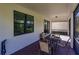 Covered patio with a table and chairs for outdoor relaxation and entertainment at 2479 Brassica Dr, North Port, FL 34289
