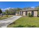 House exterior showcasing a circular driveway and manicured lawn at 27318 San Carlos Dr, Punta Gorda, FL 33983