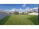 Expansive fenced backyard overlooking a serene pond, creating a private outdoor space at 341 Grande Vista Blvd, Bradenton, FL 34212