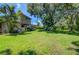 Large backyard with lush green grass and tropical plants at 3706 162Nd E Ave, Parrish, FL 34219