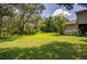 Spacious backyard with grassy area and trees at 3706 162Nd E Ave, Parrish, FL 34219