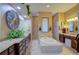 Spa-like bathroom with double vanity, large soaking tub, and decorative accents at 3706 162Nd E Ave, Parrish, FL 34219