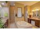 Elegant bathroom with soaking tub, double vanity, and separate shower at 3706 162Nd E Ave, Parrish, FL 34219