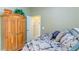 Bedroom with wooden wardrobe and patterned bedding at 3706 162Nd E Ave, Parrish, FL 34219