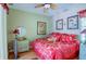 Bedroom with red bedding and a ceiling fan at 3706 162Nd E Ave, Parrish, FL 34219