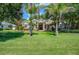Luxury home with palm trees and a spacious green lawn at 3706 162Nd E Ave, Parrish, FL 34219