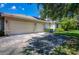 Two-car garage with driveway and solar panels at 3706 162Nd E Ave, Parrish, FL 34219