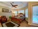 Primary bedroom with king bed, pool access, and ceiling fan at 3706 162Nd E Ave, Parrish, FL 34219