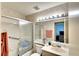Bathroom with shower/tub combo, vanity, and linen storage at 380 Three Lakes Ln # L, Venice, FL 34285