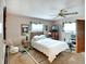 Bedroom with a double bed, ceiling fan, and dresser at 380 Three Lakes Ln # L, Venice, FL 34285