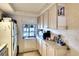 View of kitchen with wood cabinets and appliances at 380 Three Lakes Ln # L, Venice, FL 34285