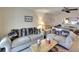 Living room with couches and a view into the dining area at 380 Three Lakes Ln # L, Venice, FL 34285