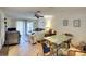 Condo living room with seating, dining area, and access to balcony at 380 Three Lakes Ln # L, Venice, FL 34285
