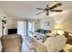 Condo living room with comfortable seating and a view to the balcony at 380 Three Lakes Ln # L, Venice, FL 34285