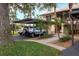 Condo parking area with covered carport and landscaping at 380 Three Lakes Ln # L, Venice, FL 34285