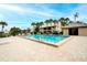 Community pool with lounge chairs and patio area at 380 Three Lakes Ln # L, Venice, FL 34285
