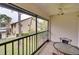Screened-in porch with patio furniture and view of trees at 380 Three Lakes Ln # L, Venice, FL 34285