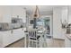 Bright dining area with modern light fixture and hardwood floors at 3866 Pin Oaks St, Sarasota, FL 34232