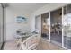 Private balcony with glass-top table and chairs, overlooking the living room at 414 Cerromar S Cir # 249, Venice, FL 34293